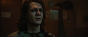 Movie still from “Insidious: The Red Door” (2023), directed by Patrick Wilson – A person with long hair; Close Up shot, Low angle