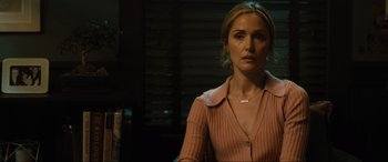 Movie still from “Insidious: The Red Door” (2023), directed by Patrick Wilson – A woman in a pink sweater is sitting in a chair; Close Up shot, Over the shoulder angle