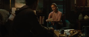 Movie still from “Insidious: The Red Door” (2023), directed by Patrick Wilson – A man and a woman sitting in front of each other holding papers; Medium shot, Over the shoulder angle