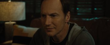 Movie still from “Insidious: The Red Door” (2023), directed by Patrick Wilson – A person wearing a jacket; Close Up shot, Over the shoulder angle