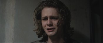 Movie still from “Insidious: The Red Door” (2023), directed by Patrick Wilson – A young man with long hair is crying; Close Up shot, Low angle