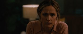 Movie still from “Insidious: The Red Door” (2023), directed by Patrick Wilson – A person sitting down with her hands on her head; Close Up shot, Over the shoulder angle