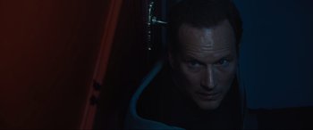 Movie still from “Insidious: The Red Door” (2023), directed by Patrick Wilson – A person looking at the camera; Close Up shot, High angle