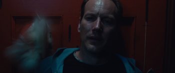 Movie still from “Insidious: The Red Door” (2023), directed by Patrick Wilson – A person wearing a black t - shirt; Close Up shot, Low angle
