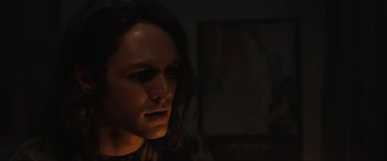 Movie still from “Insidious: The Red Door” (2023), directed by Patrick Wilson – A man with long hair is looking into the light; Close Up shot, Low angle