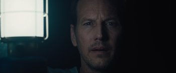 Movie still from “Insidious: The Red Door” (2023), directed by Patrick Wilson – A person's face in the dark; Close Up shot, Low angle