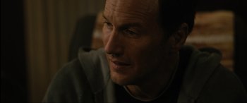 Movie still from “Insidious: The Red Door” (2023), directed by Patrick Wilson – A person looking at the camera; Close Up shot, Over the shoulder angle