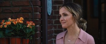 Movie still from “Insidious: The Red Door” (2023), directed by Patrick Wilson – A person outside near a brick wall; Close Up shot, Over the shoulder angle