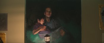 Movie still from “Insidious: The Red Door” (2023), directed by Patrick Wilson – A painting of a man holding a child in his arms; Medium shot, Low angle