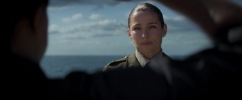 Movie still from “Interceptor” (2022), directed by Matthew Reilly – A woman in a military uniform looking at the camera; Close Up shot, Over the shoulder angle