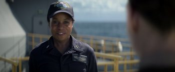 Movie still from “Interceptor” (2022), directed by Matthew Reilly – A woman wearing a hat and a uniform; Close Up shot, Over the shoulder angle