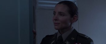 Movie still from “Interceptor” (2022), directed by Matthew Reilly – A woman in military uniform looking to her left; Close Up shot, Over the shoulder angle