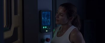 Movie still from “Interceptor” (2022), directed by Matthew Reilly – A woman standing in front of an electronic device; Close Up shot, Over the shoulder angle