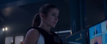 Movie still from “Interceptor” (2022), directed by Matthew Reilly – A person wearing a vest; Close Up shot, Low angle