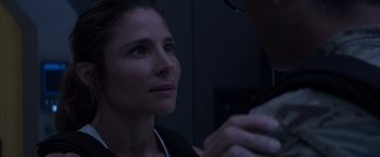 Movie still from “Interceptor” (2022), directed by Matthew Reilly – A person looking at something on a table; Close Up shot, Over the shoulder angle
