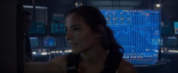 Movie still from “Interceptor” (2022), directed by Matthew Reilly – A person wearing a black tank top; Close Up shot, Over the shoulder angle