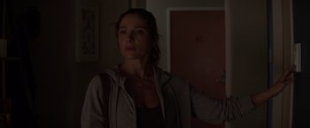 Movie still from “Interceptor” (2022), directed by Matthew Reilly – A woman standing in the dark in front of a door; Close Up shot, Over the shoulder angle