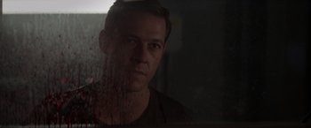 Movie still from “Interceptor” (2022), directed by Matthew Reilly – A person looking through a window; Close Up shot, Over the shoulder angle