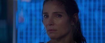 Movie still from “Interceptor” (2022), directed by Matthew Reilly – A woman's face in front of a window; Close Up shot, Over the shoulder angle