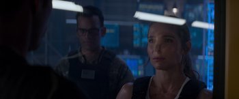 Movie still from “Interceptor” (2022), directed by Matthew Reilly – A man and a woman are looking at a monitor; Close Up shot, Over the shoulder angle