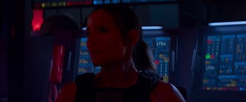 Movie still from “Interceptor” (2022), directed by Matthew Reilly – A woman with a ponytail is looking into the distance; Close Up shot, Low angle