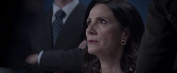 Movie still from “Interceptor” (2022), directed by Matthew Reilly – A person wearing a suit and a tie; Close Up shot, Over the shoulder angle