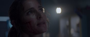 Movie still from “Interceptor” (2022), directed by Matthew Reilly – A person looking up at a light; Close Up shot, Low angle