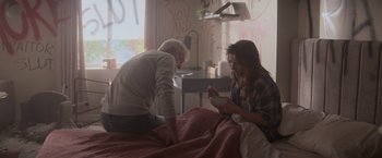 Movie still from “Interceptor” (2022), directed by Matthew Reilly – A man and a woman sitting on a bed; Medium shot, Over the shoulder angle