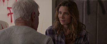 Movie still from “Interceptor” (2022), directed by Matthew Reilly – A man and a woman are looking at one another; Close Up shot, Over the shoulder angle