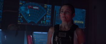 Movie still from “Interceptor” (2022), directed by Matthew Reilly – A woman standing in front of a computer screen; Close Up shot, Over the shoulder angle