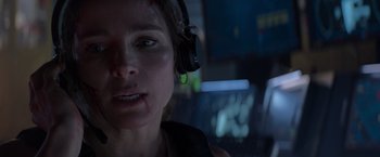 Movie still from “Interceptor” (2022), directed by Matthew Reilly – A person with headphones on; Close Up shot, Low angle