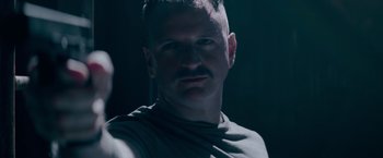 Movie still from “Interceptor” (2022), directed by Matthew Reilly – A person wearing a shirt; Close Up shot, Low angle