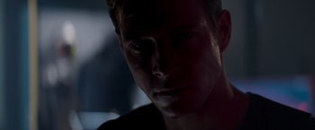 Movie still from “Interceptor” (2022), directed by Matthew Reilly – A man's face in the dark; Close Up shot, Over the shoulder angle