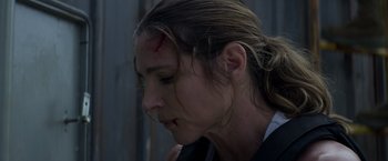 Movie still from “Interceptor” (2022), directed by Matthew Reilly – A person with a head wound; Close Up shot, Low angle