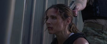 Movie still from “Interceptor” (2022), directed by Matthew Reilly – A person holding a gun; Close Up shot, Low angle