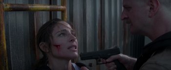 Movie still from “Interceptor” (2022), directed by Matthew Reilly – A woman holding a gun up to her face; Close Up shot, Over the shoulder angle
