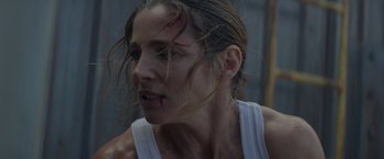 Movie still from “Interceptor” (2022), directed by Matthew Reilly – A person with blood on her face; Close Up shot, Low angle