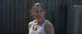 Movie still from “Interceptor” (2022), directed by Matthew Reilly – A woman in a white shirt with a scar on her face; Close Up shot, Low angle