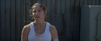 Movie still from “Interceptor” (2022), directed by Matthew Reilly – A woman with a bandage on her arm and a bandage on her face; Close Up shot, Over the shoulder angle