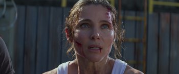 Movie still from “Interceptor” (2022), directed by Matthew Reilly – A person with blood all over her face; Close Up shot, Over the shoulder angle
