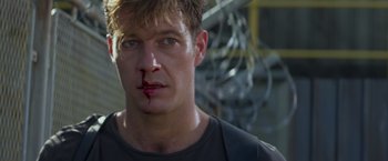 Movie still from “Interceptor” (2022), directed by Matthew Reilly – A person with blood on his face; Close Up shot, Over the shoulder angle