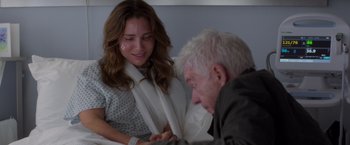 Movie still from “Interceptor” (2022), directed by Matthew Reilly – An older man and a young woman in a hospital bed; Close Up shot, Over the shoulder angle