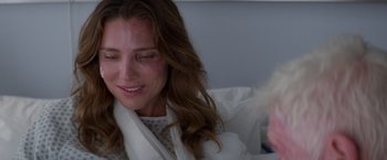 Movie still from “Interceptor” (2022), directed by Matthew Reilly – A person sitting on a bed; Close Up shot, Over the shoulder angle