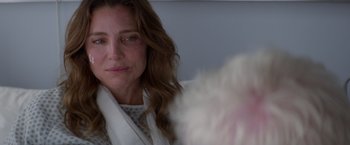 Movie still from “Interceptor” (2022), directed by Matthew Reilly – A person sitting down looking sad; Close Up shot, Over the shoulder angle