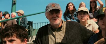 Movie still from “Interstellar” (2014), directed by Christopher Nolan – An older man wearing a hat and a sweater; Close Up shot, Over the shoulder angle