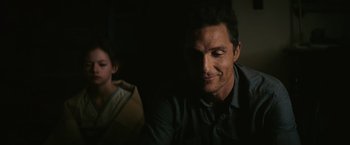 Movie still from “Interstellar” (2014), directed by Christopher Nolan – A person sitting in a room; Close Up shot, Over the shoulder angle