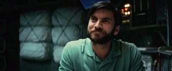 Movie still from “Interstellar” (2014), directed by Christopher Nolan – A man with a beard is sitting in a chair; Close Up shot, Over the shoulder angle