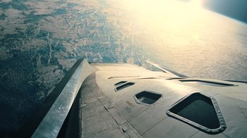 Movie still from “Interstellar” (2014), directed by Christopher Nolan – An aerial view of the wing of an airplane flying in the sky; Extreme Wide shot, Overhead angle