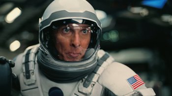 Movie still from “Interstellar” (2014), directed by Christopher Nolan – A person wearing a spacesuit; Close Up shot, Overhead angle