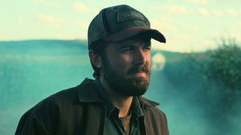 Movie still from “Interstellar” (2014), directed by Christopher Nolan – A man with a beard wearing a hat and jacket; Close Up shot, Low angle